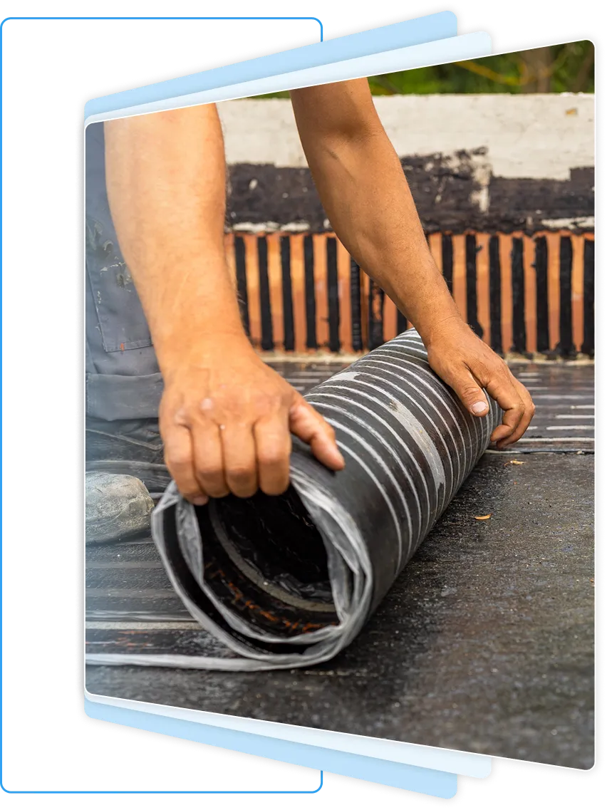 Contractor unrolling heavy-duty black corrugated drainage pipe for a crawl space water management system.