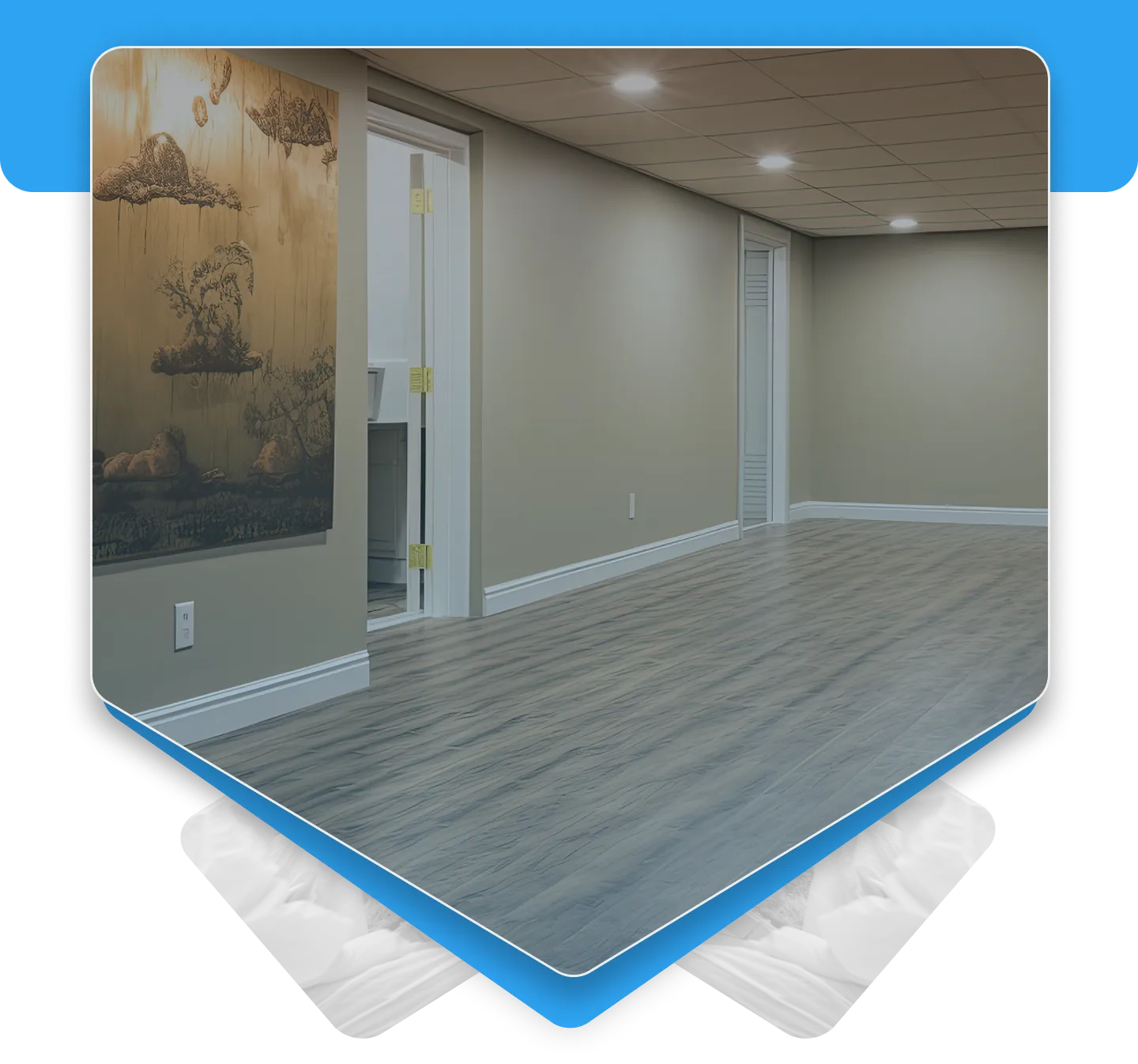 Beautifully finished modern basement interior featuring grey wood-look flooring, painted walls, and a drop ceiling.